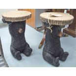 SIDE TABLES, a pair, Black Forest style, with circular tops supported by a bear, in coloured resin,