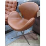 CHAIR, in the style of Arne Jacobsen's Swan chair in a brown leather on steel base.