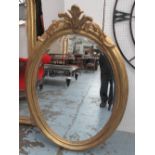 OVAL MIRROR, with bevelled glass in a gilded frame, 131cm x 89cm.