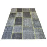 PATCHWORK RUG BY VENTIQUE, 244cm x 177cm, en gris tiled designs with yellow stitching.