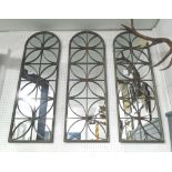 GARDEN MIRRORS, a set of three, in slender frames with domed tops, 40cm x 118cm.