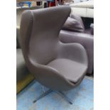 SWIVEL BASED LOUNGE CHAIR, in the style of Arne Jacobsen's Egg chair, in a brown finish.