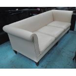 SOFA, three seater, in soft cream leather with roll arms and square tapering legs with brass caps,