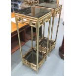 LAMP TABLES, a pair, in brass finish with smoked glass shelves, 35cm x 35cm x 100cm H.