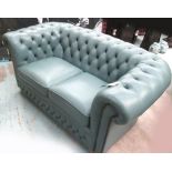 CHESTERFIELD SOFA, two seater, buttoned in blue on bun supports, 156cm L.