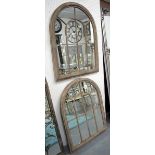ARCHED GARDEN MIRRORS, a pair, with domed frames in a rusted finish, 88cm x 69cm.