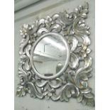 MIRROR, circular, in an ornate silver painted square frame, 120cm x 120cm.