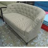 SOFA, in herringbone fabric, button backed on turned ebonised feet with brass shoes,