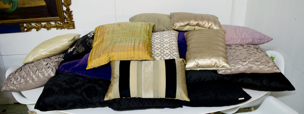 CUSHIONS, approx twenty five, a large quantity, many black, some coloured and patterned.