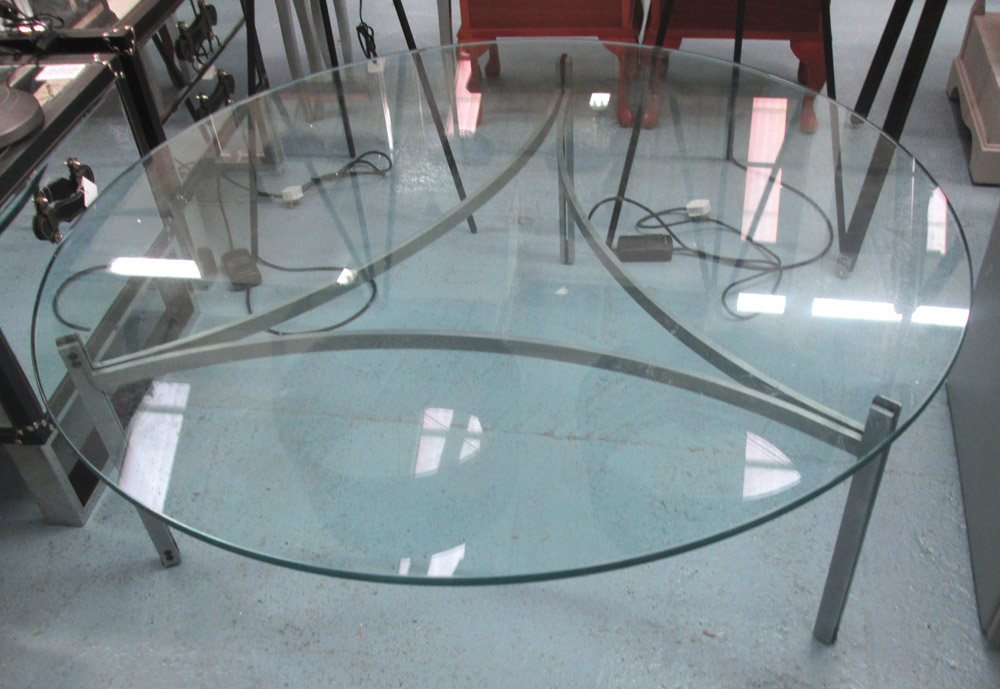 LOW TABLE, circular glass top on a bent metal base, 120cm dia and 44cm H.