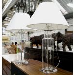 LAMPS, a pair, clear glass canister form with white shades, 80cm H.