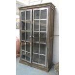 GLAZED BOOKCASE, distressed effect with four internal shelves behind stainless steel fronted doors,