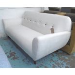 SOFA, ivory upholstery with black button detail, on turned wooden supports,