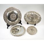 PERSIAN SILVER HAND MIRRORS, four various, with repousse decorated backs, largest 33cm diam.