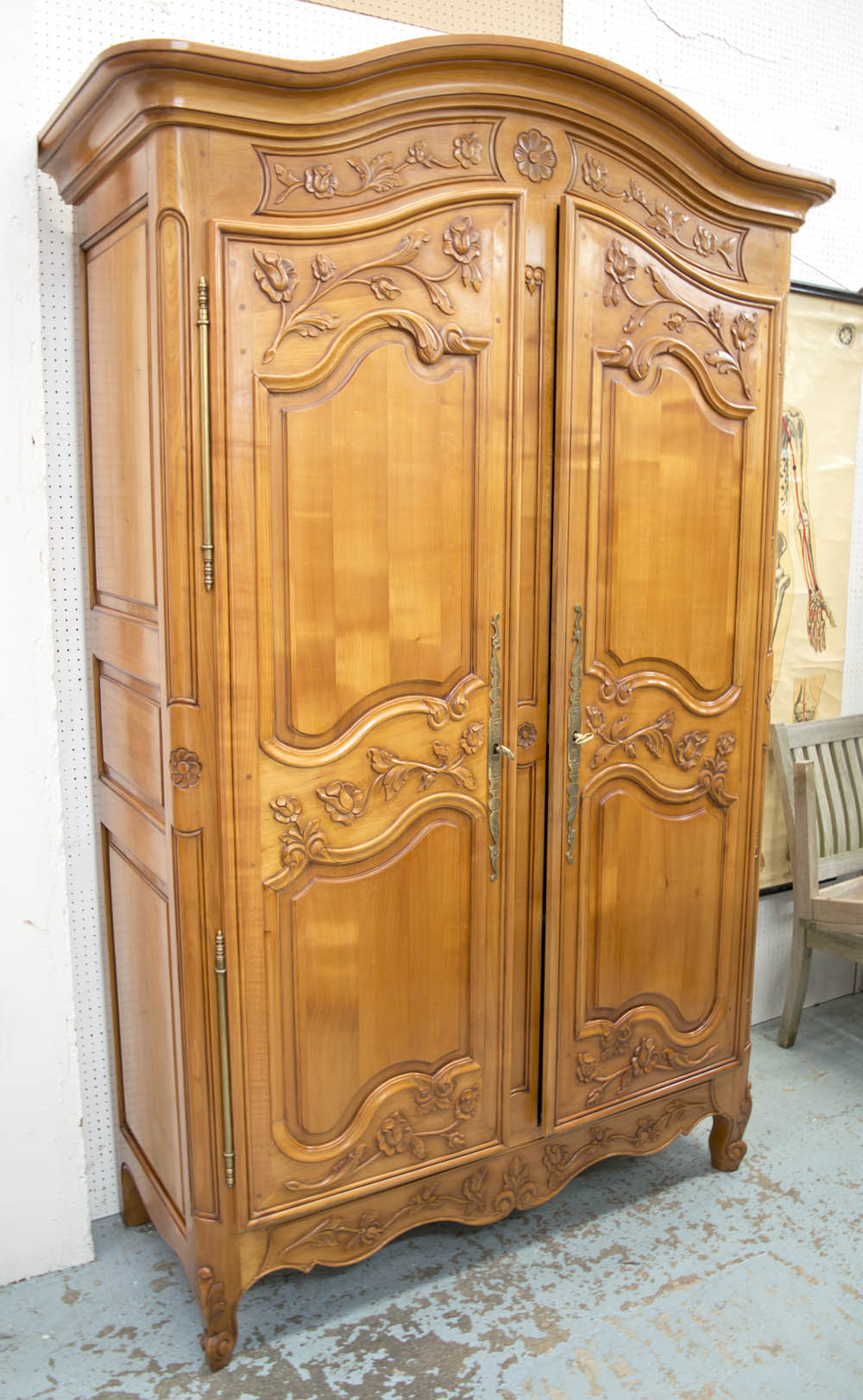 ARMOIRE, Louis XV style cherrywood with two carved doors enclosing shelves and a hanging rail,