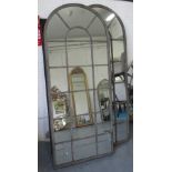 WALL MIRRORS, a pair, architectural metal arched frames, 160cm H x 66cm W.