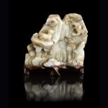 CARVED WHITE AND GREY JADE BOULDERQING DYNASTY, 18TH CENTURYdeeply carved on both sides, depicting a
