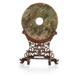 MOTTLED JADE BI DISC ON BLACKWOOD STANDQING DYNASTY, 18TH/19TH CENTURYthe stone of a mottled