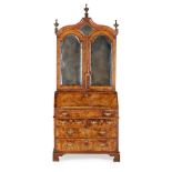 GEORGE I WALNUT BUREAU BOOKCASE CIRCA 1720 the moulded arched cornice mounted with turned finials