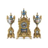 FRENCH GILT METAL AND PORCELAIN MOUNTED CLOCK GARNITURE 19TH CENTURY the clock with an urn finial