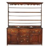 GEORGE III OAK AND WALNUT DRESSER 18TH CENTURY the moulded cornice above a dentil and scroll cut