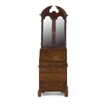 GEORGE II SMALL WALNUT BUREAU BOOKCASE CIRCA 1730 the moulded broken arch pediment above a pair of