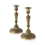 PAIR OF NEOCLASSICAL GILT BRONZE CANDLESTICKS EARLY 19TH CENTURY the urn form candle nozzles with