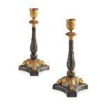 PAIR OF REGENCY PATINATED AND GILT BRONZE CANDLESTICKS EARLY 19TH CENTURY with cast nozzles and drip