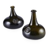 NEAR PAIR OF OLIVE-GREEN GLASS 'ONION' BOTTLES EARLY 18TH CENTURY each with an elongated neck and