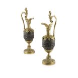PAIR OF PATINATED AND POLISHED BRASS EWERS, AFTER CLODION 19TH CENTURY the handles with putti