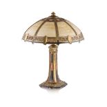 AMERICAN SCHOOL CAST METAL LAMP, EARLY 20TH CENTURY patinated cast metal with slag glass shade