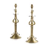 ARTS & CRAFTS PAIR OF EXTENDING BRASS TABLE LAMP BASES, CIRCA 1900 each with scrolling brackets