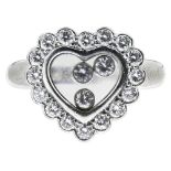 CHOPARD - A 'Happy Diamonds' ringmodelled as a heart, the glazed compartment with three 'loose'