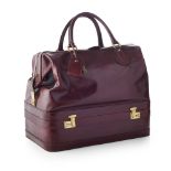 MADLER - A mid-20th century travel bagmodelled in a burgundy leather, with brushed brass fittings,