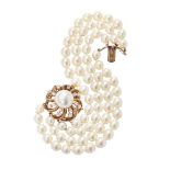 SEAMAN SCHEPPS - A pearl and diamond set braceletcomposed of four rows of uniform cultured pearls,