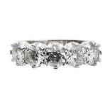 A five stone diamond ringclaw set with a single row of five round brilliant cut diamonds, to a plain