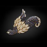 JAHAN GENEVA - A diamond and sapphire set broochmodelled as a stylised bird, pavé set in yellow