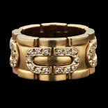 CARTIER - A diamond set ringcomposed of curved, stylised links set with small round cut diamonds, in