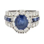 A sapphire and diamond set cluster ringclaw set with and oval cut sapphire in a single border of