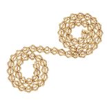 A long decorative neck chain composed of reeded oval links with applied circular links, box