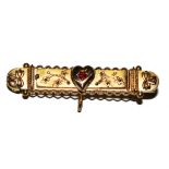 A 9 carat gold bar brooch set with a garnet