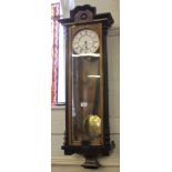 A 19th century-style mahogany and ebonised Viennese wall clock with shaped cornice, fluted supports,