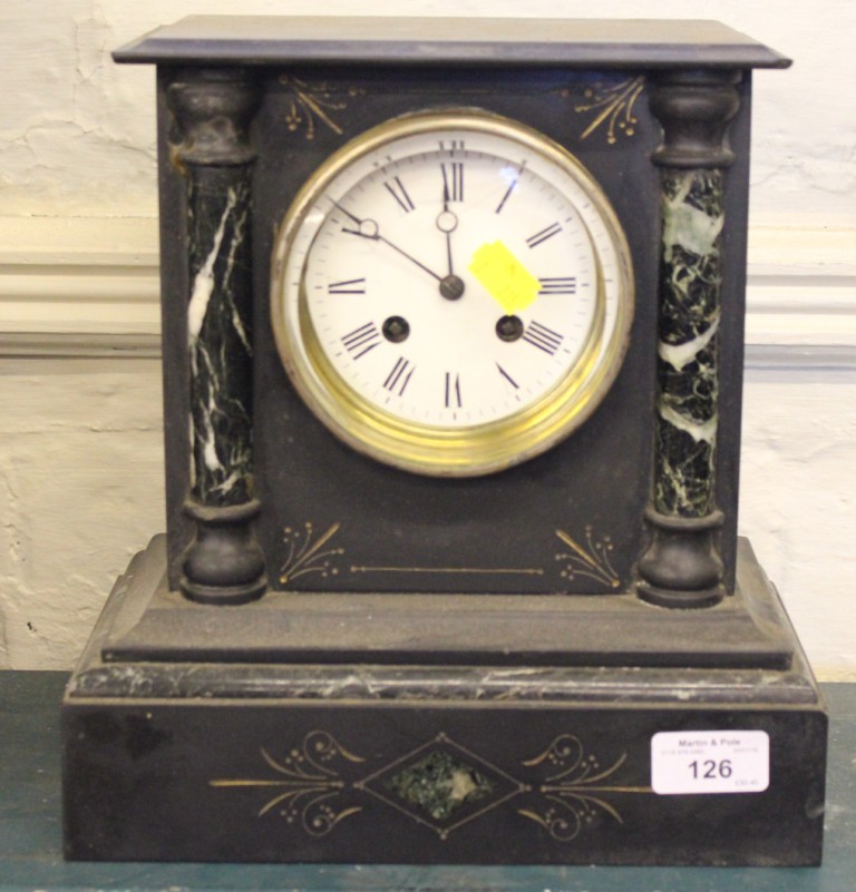A Victorian slate and green marble mantel clock with enamelled dial and bevelled glass, the French
