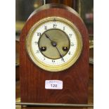 A late 19th century clock movement and brass dial with enamel chapter ring in later arched case,