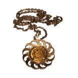 A coin necklace set in 9 carat gold