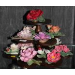 Capodimonte and The Franklin Mint: a porcelain floral display on a wooden three tier stand, stand