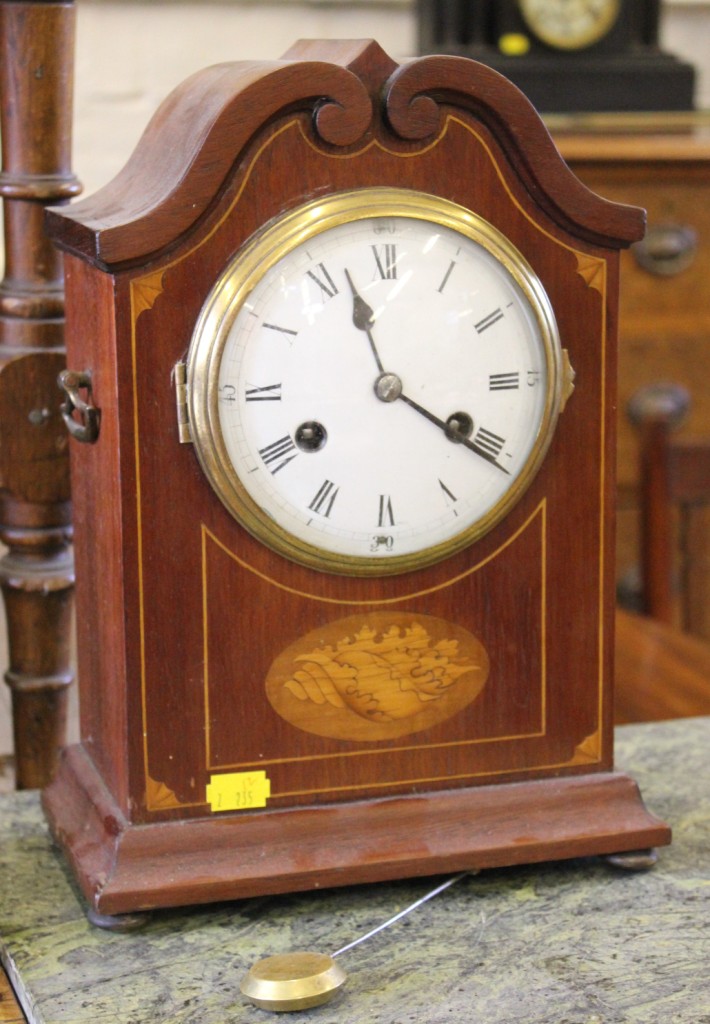 An Edwardian inlaid mahogany mantel clock, the swan neck pediment case with shell motif on brass bun