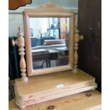 A pine toilet mirror, with rectangular plate, turned supports and platform base on bun feet, 48.