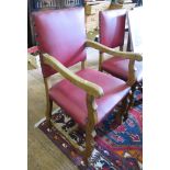 A set of six commonwealth style oak chairs, including two carvers, the leatherette upholstered backs