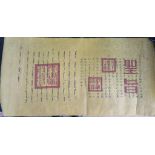 A Chinese yellow silk panel, filled with calligraphy and red stamps, 42cm x 92cm